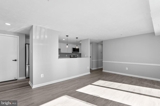 unfurnished living room with dark hardwood / wood-style flooring