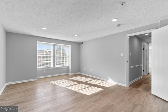 empty room featuring hardwood / wood-style floors and a textured ceiling