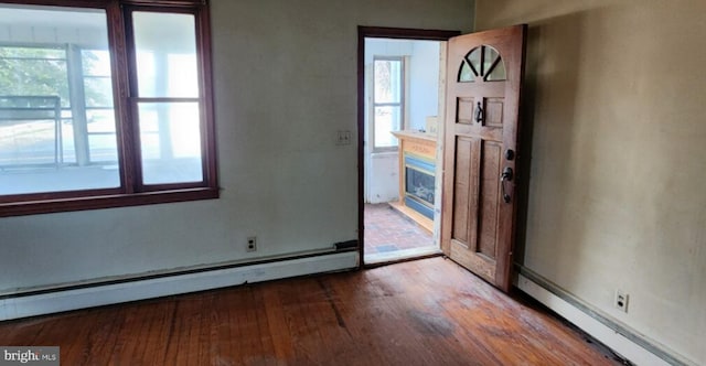 foyer featuring a baseboard radiator and wood-type flooring