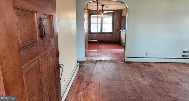 entrance foyer featuring ceiling fan, dark hardwood / wood-style flooring, and a baseboard heating unit