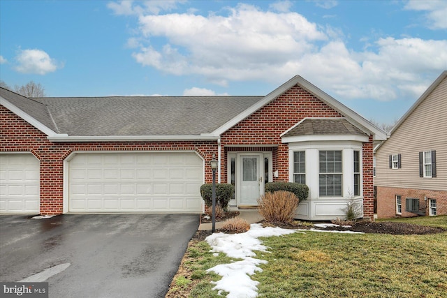 view of front of house with a garage and a front lawn