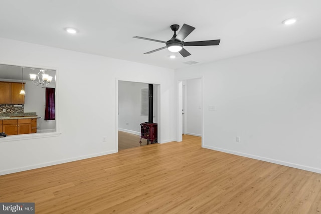 unfurnished living room featuring light wood-type flooring, a ceiling fan, and baseboards