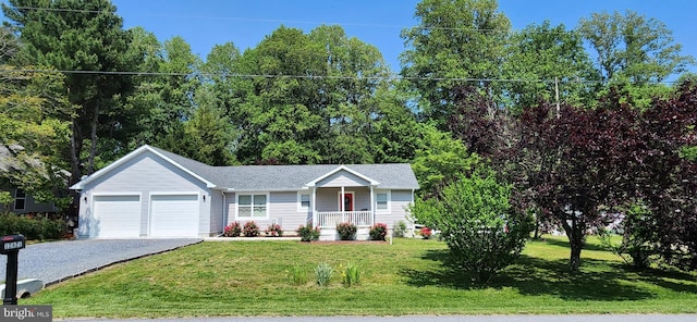 single story home with driveway, a porch, an attached garage, and a front yard