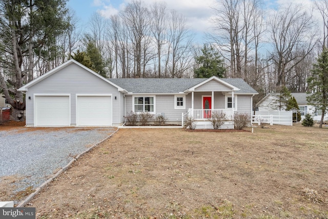 ranch-style house with a garage, covered porch, a front yard, and gravel driveway