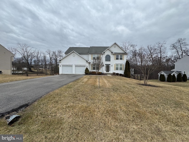 view of front of home with a garage and a front yard