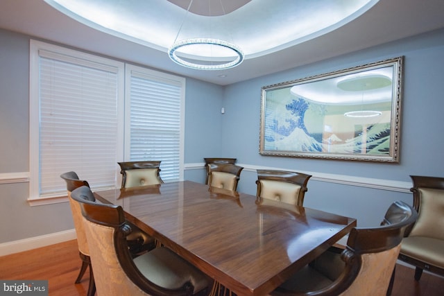 dining area with baseboards and wood finished floors