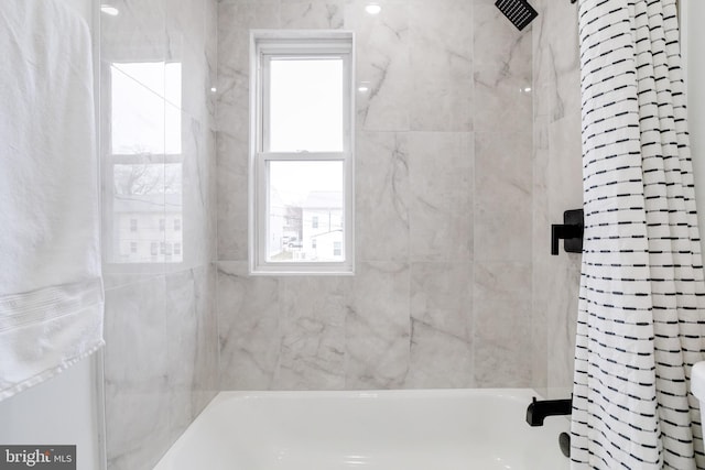 bathroom featuring shower / bath combo with shower curtain