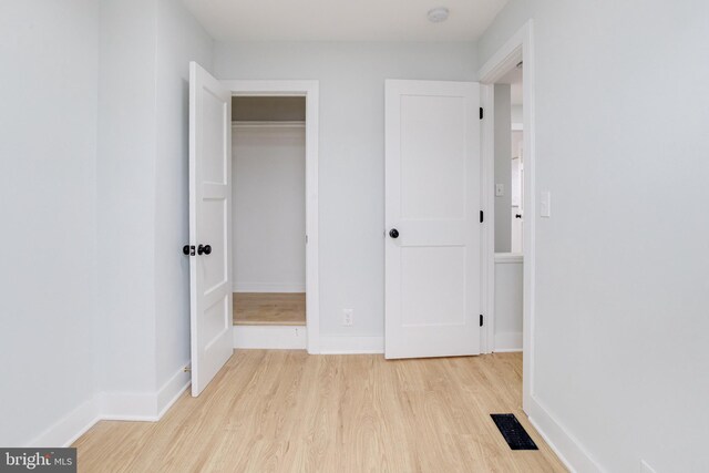 corridor with light wood-type flooring