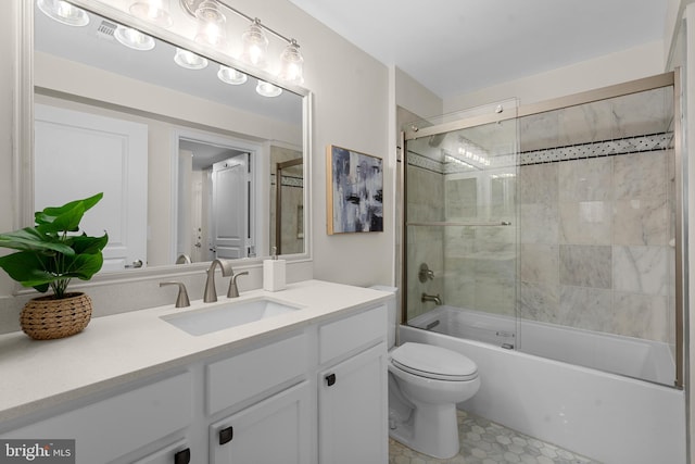 full bathroom with vanity, toilet, and combined bath / shower with glass door