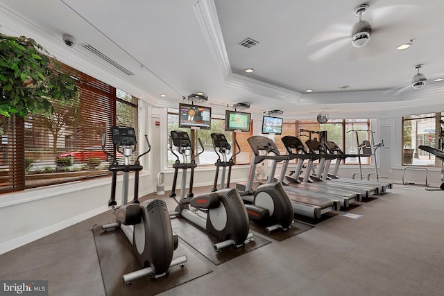 exercise room featuring crown molding, ceiling fan, and a tray ceiling