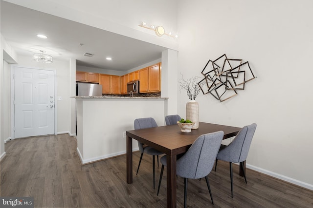 dining room with dark hardwood / wood-style flooring