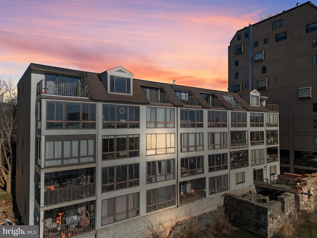 view of outdoor building at dusk