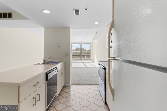 kitchen featuring sink, stainless steel electric range, black dishwasher, white refrigerator, and light carpet