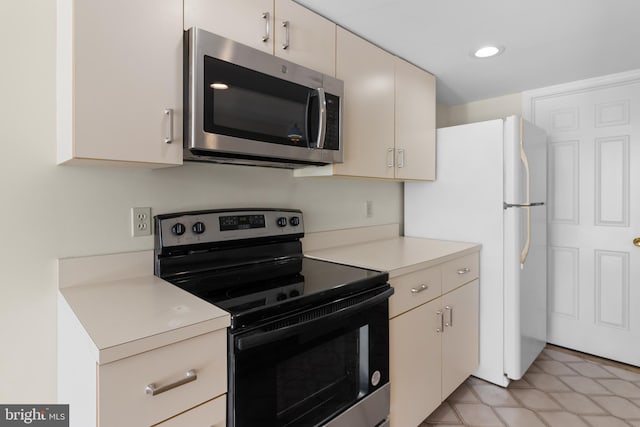 kitchen with stainless steel appliances and cream cabinets