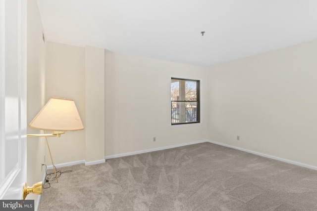 unfurnished room with light colored carpet