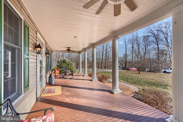 wooden terrace with ceiling fan and a porch