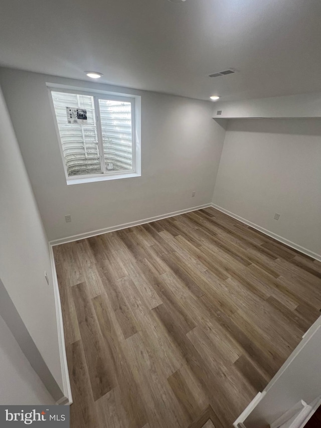 basement with hardwood / wood-style floors