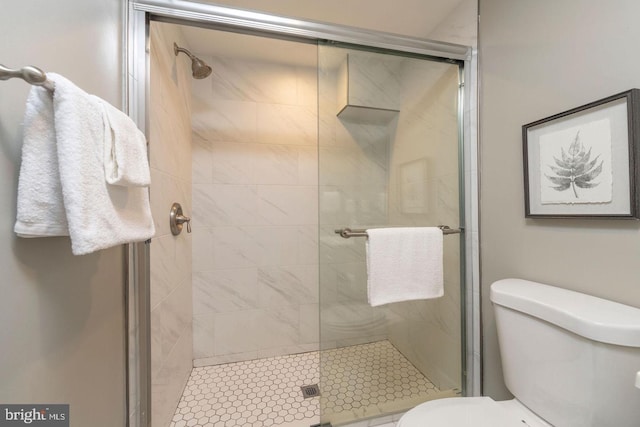 bathroom featuring toilet and an enclosed shower