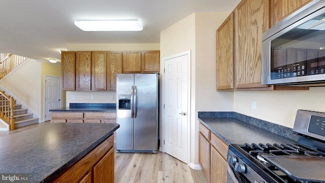 kitchen featuring appliances with stainless steel finishes and light wood-type flooring