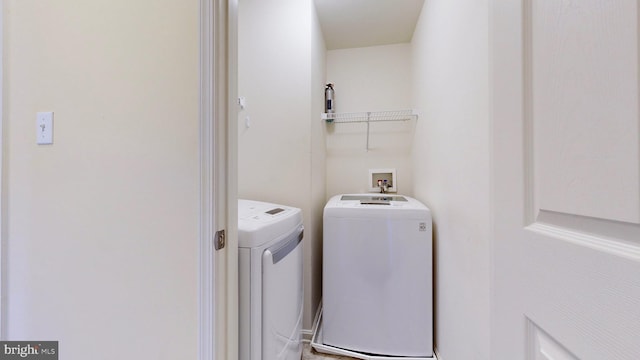 clothes washing area with independent washer and dryer