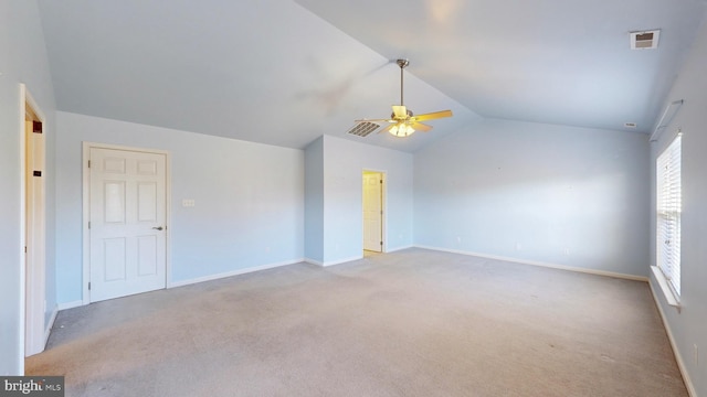 carpeted empty room with ceiling fan and lofted ceiling