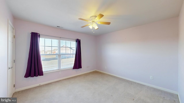 unfurnished room featuring ceiling fan and light colored carpet