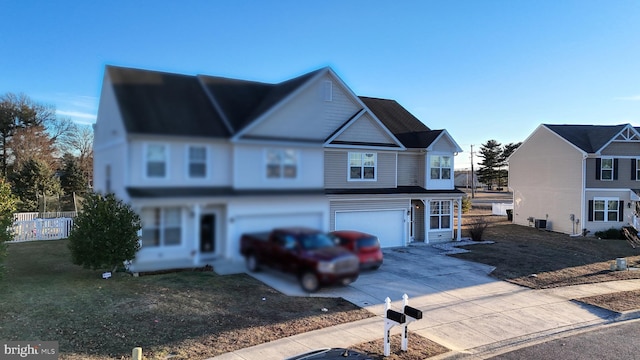 front of property with central AC unit and a garage