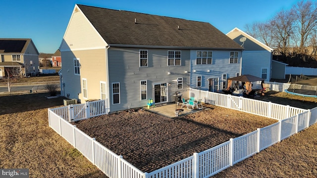 rear view of property with a patio and central AC