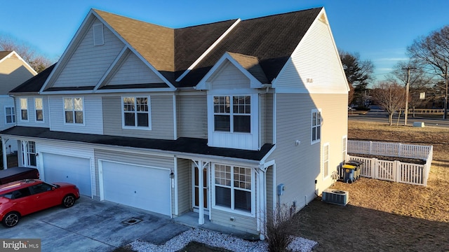 view of front of property with a garage and central air condition unit