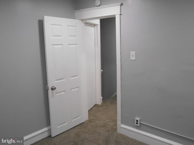 interior space featuring dark colored carpet