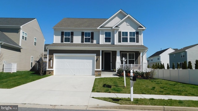 view of front of property with a garage, a front lawn, and a porch