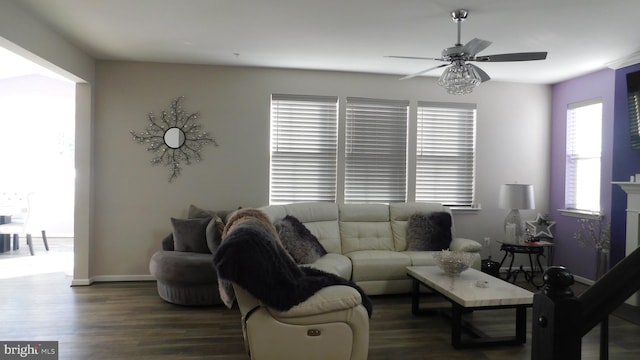 living room with dark wood-type flooring and ceiling fan