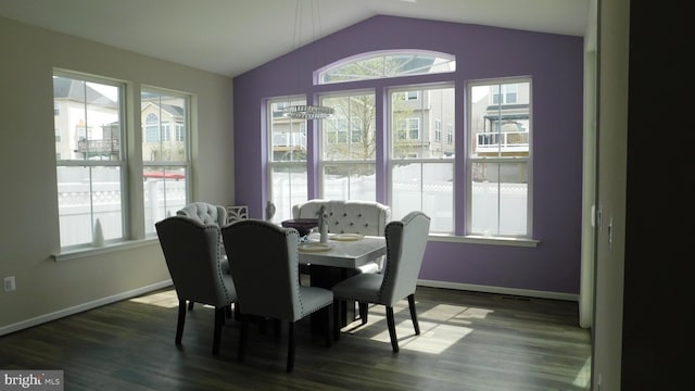 dining area with hardwood / wood-style flooring and lofted ceiling