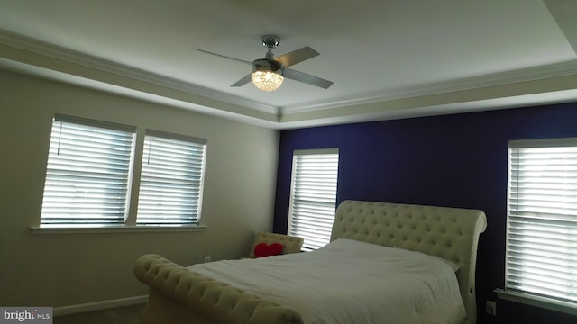 bedroom featuring crown molding, ceiling fan, and multiple windows