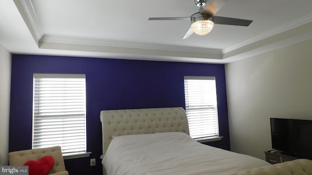 bedroom featuring multiple windows, crown molding, and ceiling fan