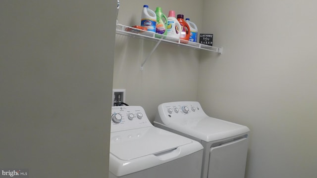 washroom with washing machine and dryer