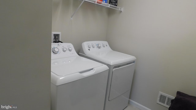 washroom with washer and dryer