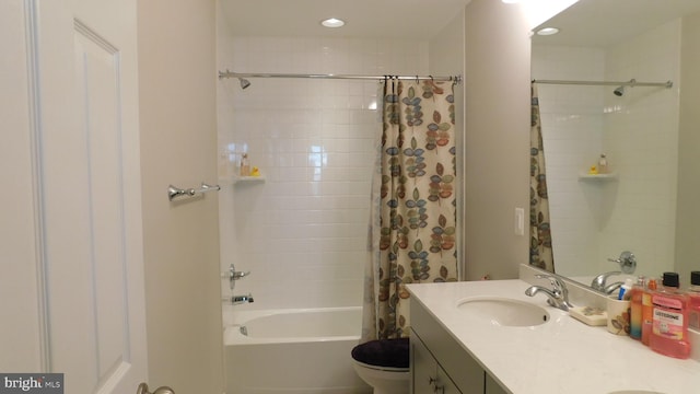 full bathroom featuring vanity, shower / bath combo, and toilet