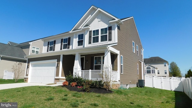 craftsman-style home with a porch, a garage, and a front yard