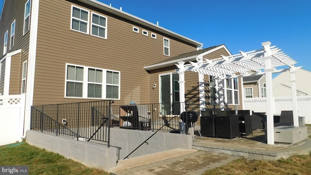 rear view of house featuring a patio area and a pergola