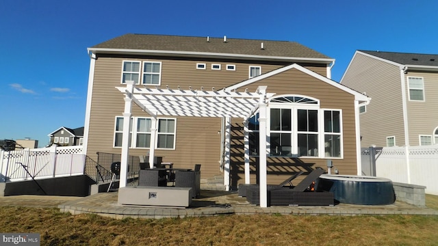 rear view of property with a pergola and a patio