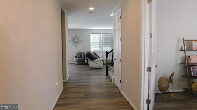 corridor with dark hardwood / wood-style flooring