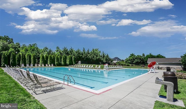 view of swimming pool with a patio area