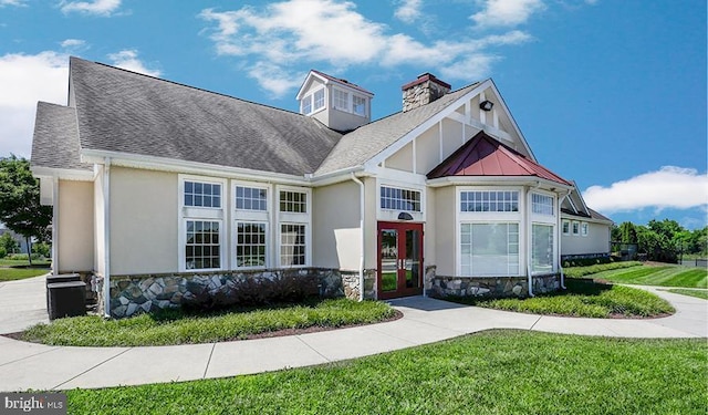 view of front of house featuring a front yard and french doors