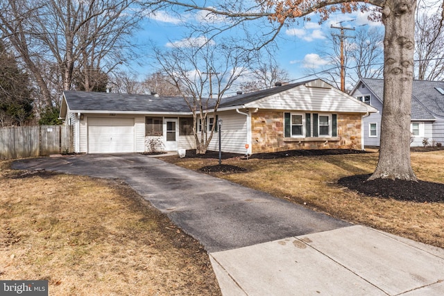 single story home featuring a garage and a front yard