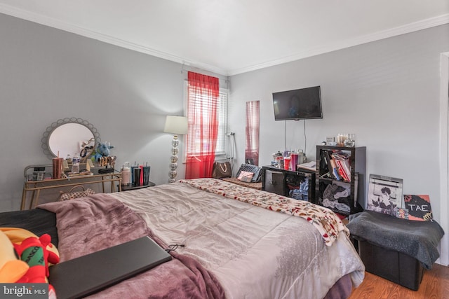 bedroom with crown molding and wood-type flooring