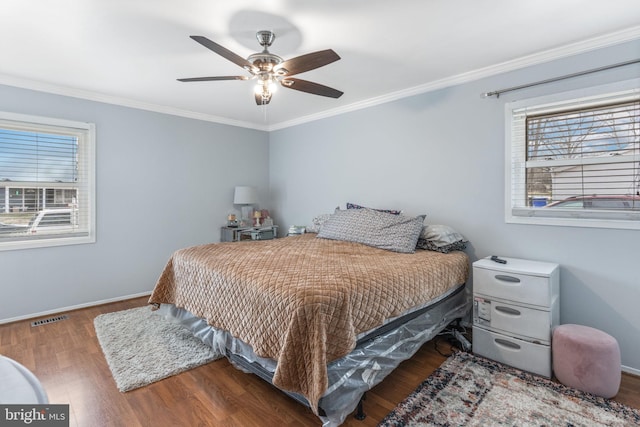 bedroom featuring crown molding, ceiling fan, dark hardwood / wood-style flooring, and multiple windows