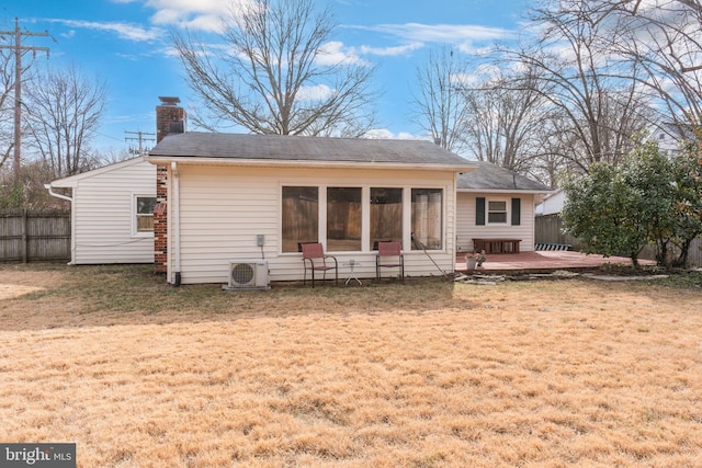 rear view of house with a patio, ac unit, a sunroom, and a lawn