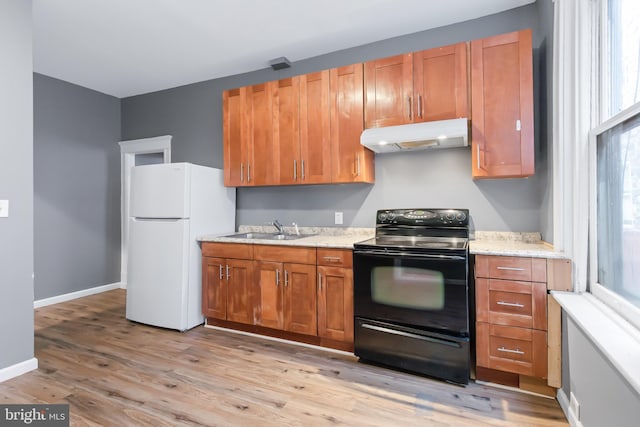 kitchen with light wood-type flooring, sink, black electric range, and white refrigerator