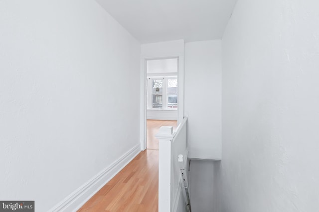 hallway with light hardwood / wood-style flooring